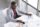 Top view of serious confident young dark skinend male economist, uses paper documents, checks monthly report, has confident expression, sits at his cabinet. People, job and business concept.